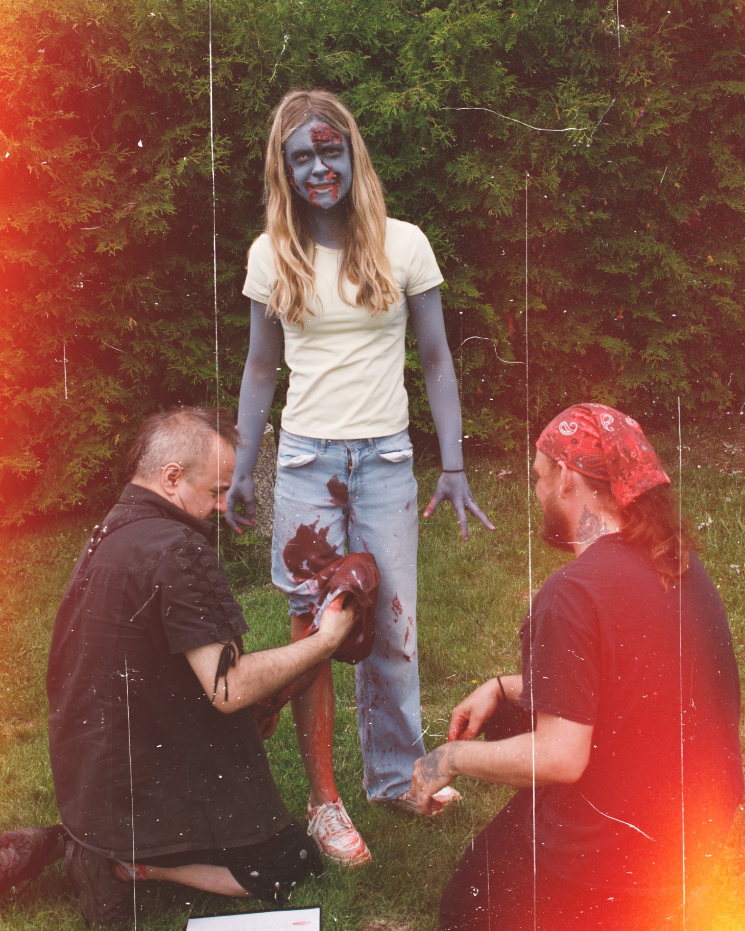 Crew applying blood effects to actor on set